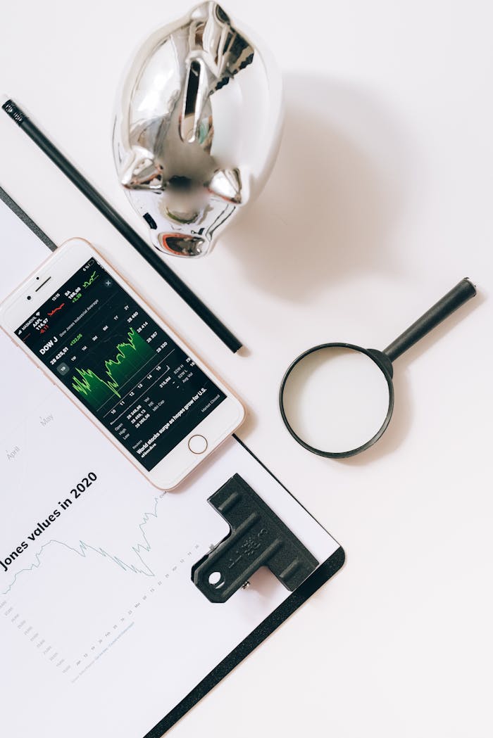 A Smartphone and Magnifying Glass on the White Table